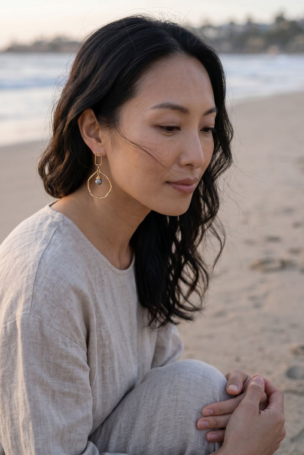Sand and Sea geometric gold-tone drop earrings with faceted pyrite stone accent.