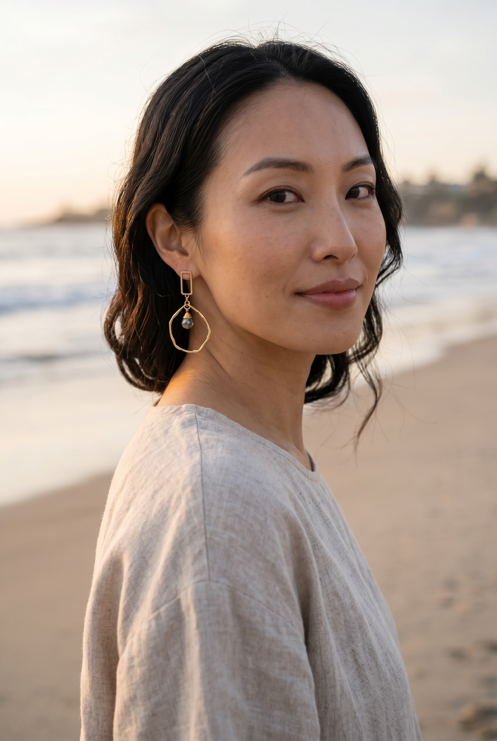 Sand and Sea geometric drop earrings with gold-tone finish, pyrite stone accent, and unique hoop design.