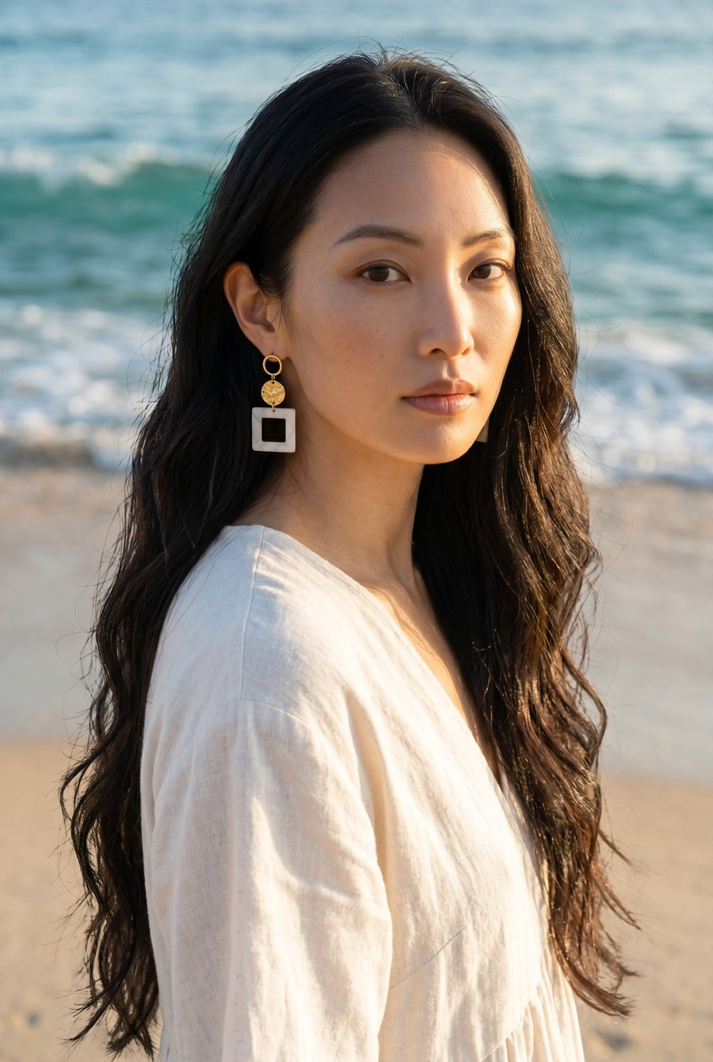 Sand and Sea geometric drop earrings with gold-tone stud and matte white square pendant.