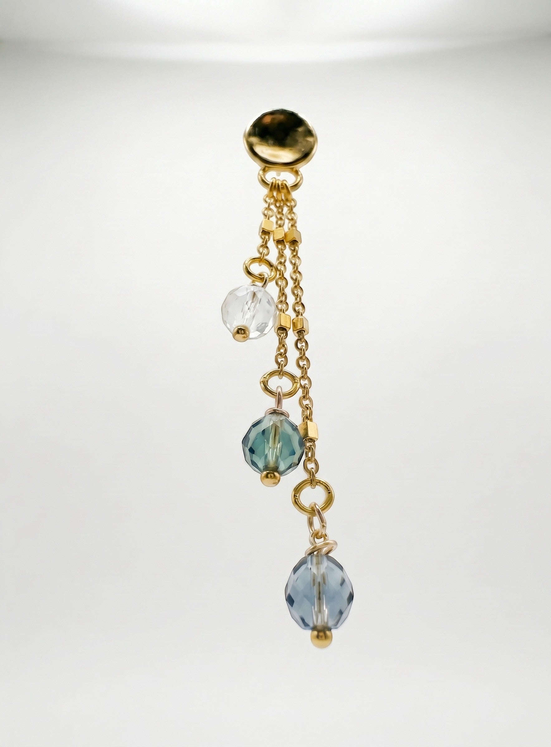 Sand and Sea gold plated drop earrings with clear, teal, and blue faceted beads on delicate chains.