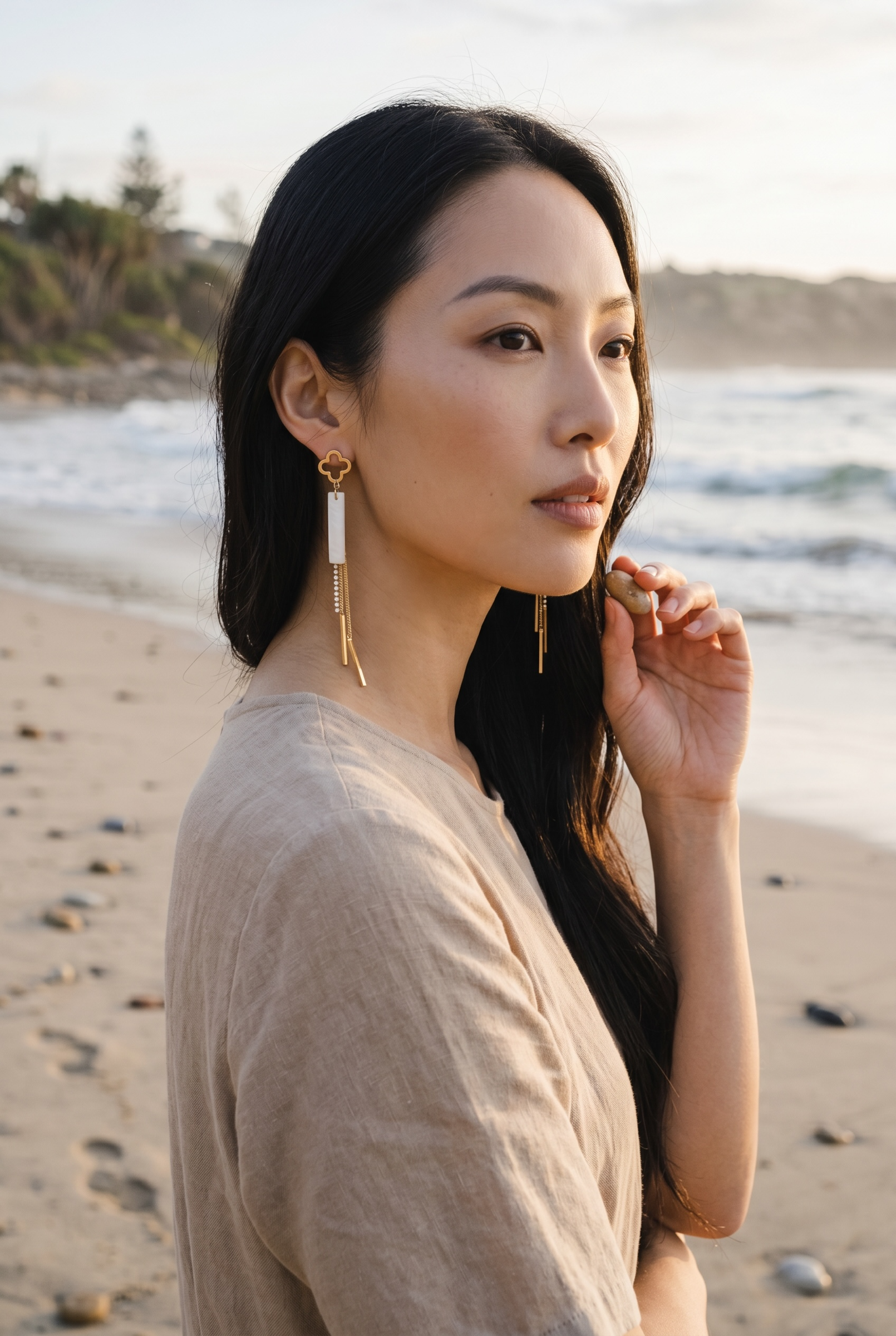 Sand and Sea gold clover dangle earrings with white stone inlay and crystal chain accents