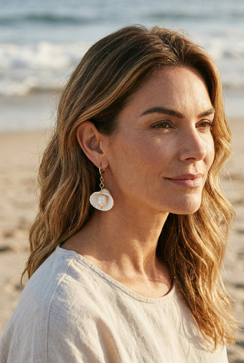 Sand and Sea 18k gold dangle earrings with white shell and pearl accents. Coastal charm.