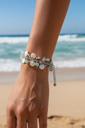 Sand and Sea handmade beach charm bracelet with white lentil shells, turquoise rondelles, and sterling silver.
