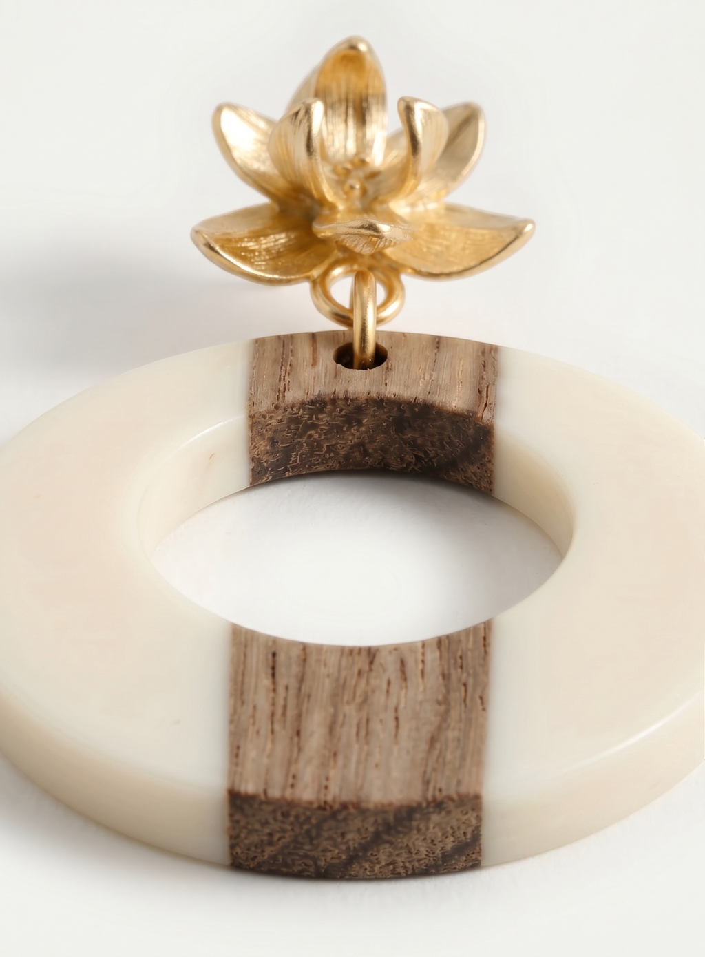 Sand and Sea statement hoop earrings with gold lotus stud, featuring cream and wood tones.