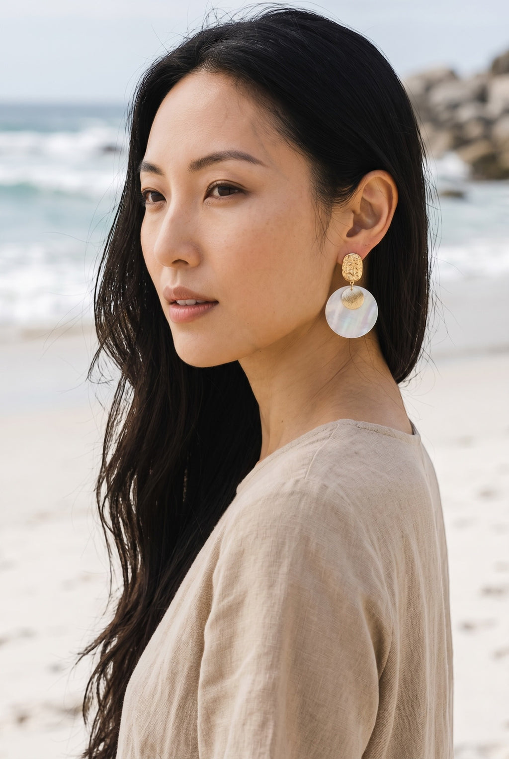 Sand and Sea textured gold-tone metal and iridescent shell disc drop earrings.