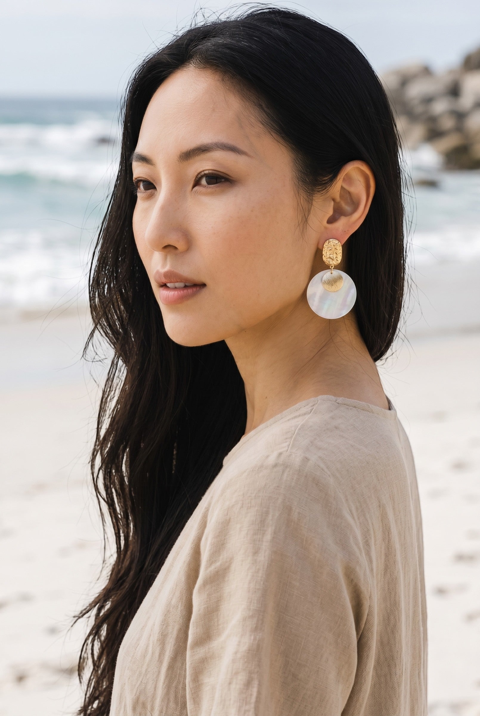 Sand and Sea textured gold-tone metal and iridescent shell disc drop earrings.