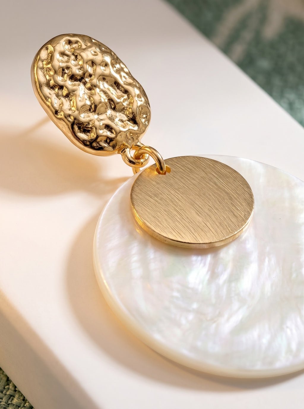 Sand and Sea textured gold-tone metal and iridescent shell disc drop earrings.