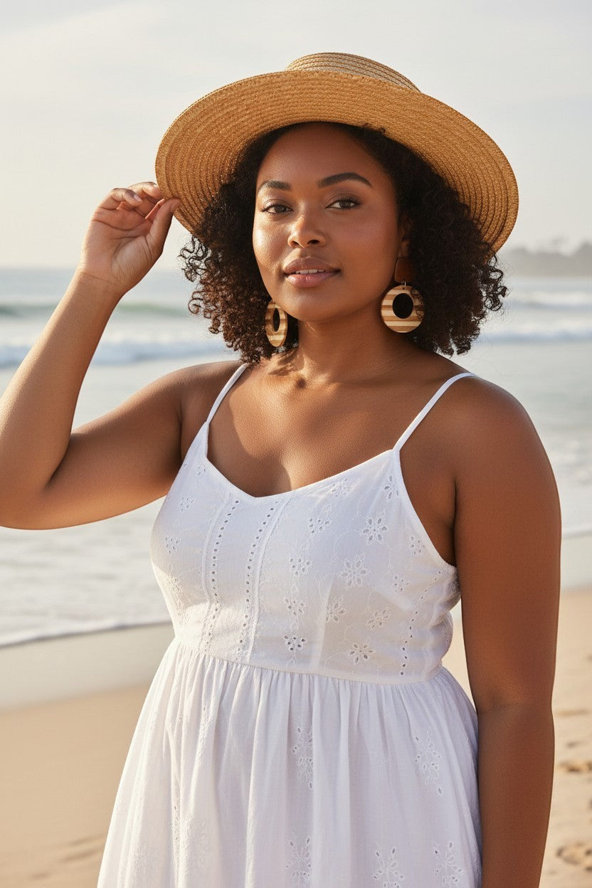 Sand and Sea boho wood and white resin hoop earrings with striped pattern, worn by a woman on the beach.